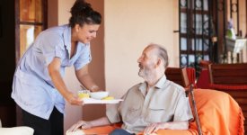 Home Healthcare Nurse serving Lunch Photo