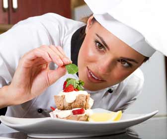 Female Chef Putting the Finishing Touches on a Dessert Photo