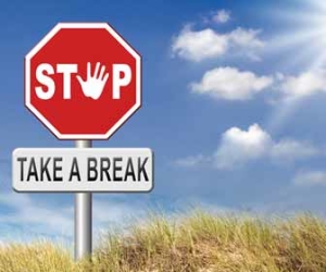 Stop and Take A Break Against Blue Sky Graphic