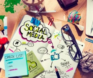 social media concepts on notepad on desk image