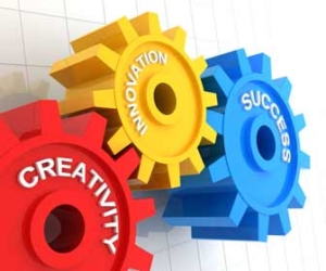 Red, yellow, and blue gears spinning ideas of creativity, innovation, and success graphic