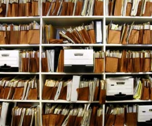 Stacks of HR documents on shelf