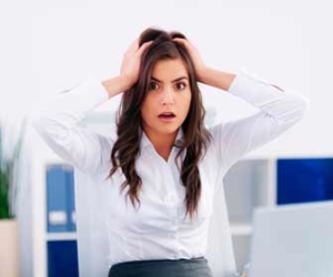 HR professional holding head after making a big mistake picture