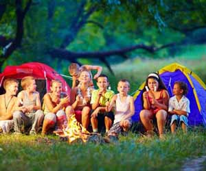 Summer Camp Kids Roasting Marshmallows by Campfire