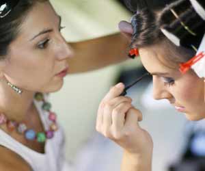 Makeup Artist Working on Model Before Photo Shoot