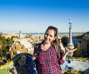 Woman tour guide shows sites while standing in front of city