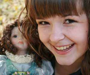 Little Girl shows off her favorite doll photo