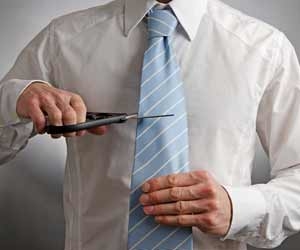 Man with scissors cutting tie before quitting