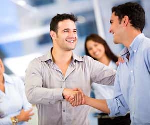 Man starting conversation and shaking hands at networking event