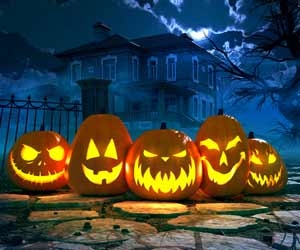 Jack-o-lanterns in front of haunted house for Halloween