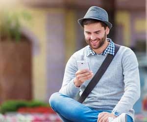 Man enjoying working in the sharing economy while checking smartphone
