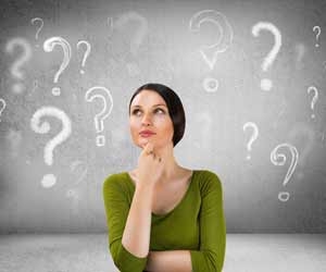 Woman pondering question with question mark graphics in background