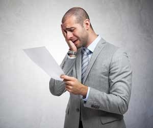 A job seeker reads a rejection letter
