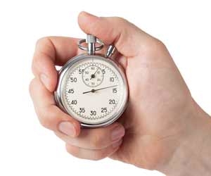 Hand holding stop watch trying to master time management