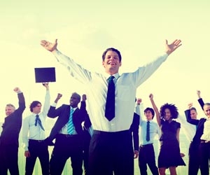 Excited business team with hands in the air