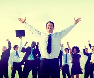 Excited business team with hands in the air