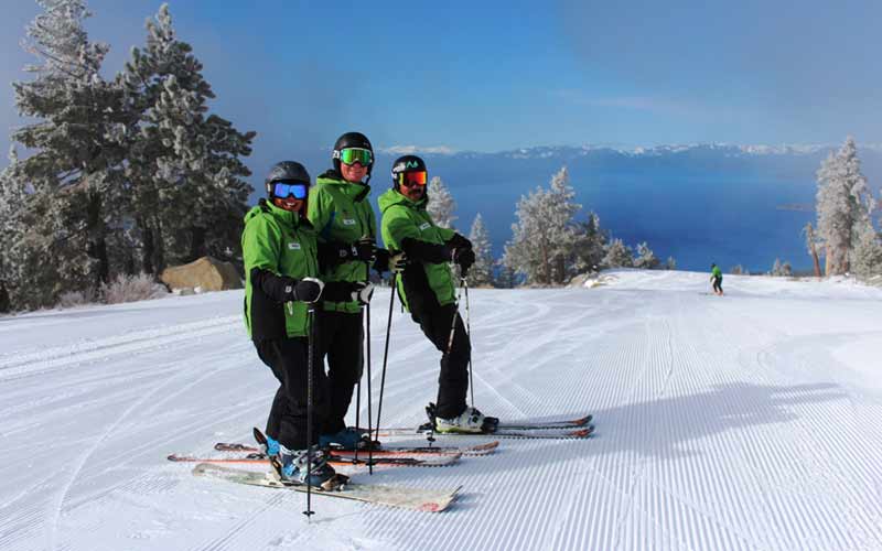 Ski Instructors at Diamond Peak Ski Resort Pose for Photo While Skiing
