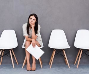 Lone job seeker sits on chair while waiting for job interview