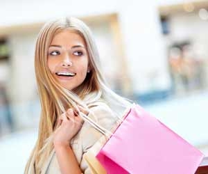 Girl with shopping bags over shoulder