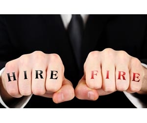 Professional with "hire" and "fire" tattoos on fists