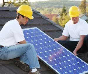 Solar Panel Installers installing a Solar Panel on a Roof