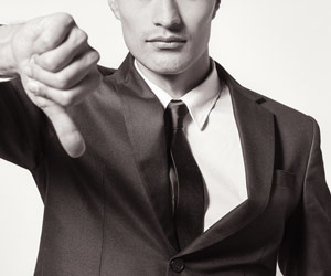 Man in suit giving a big thumbs down