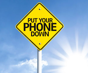 Street sign that says "put your phone down"