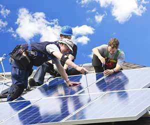 Solar Panel Installers on Roof Phot0