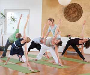 Yoga Instructor works with her Yoga Students