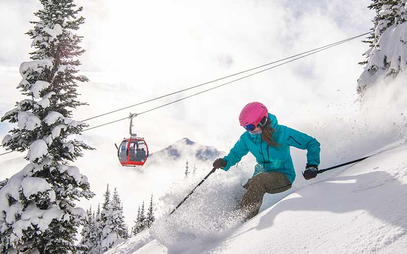 Female Skier Skiing the Fresh Powder at Crystal Mountain Ski Resort