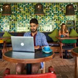 Guru Freelance Worker Working at Coffee Shop